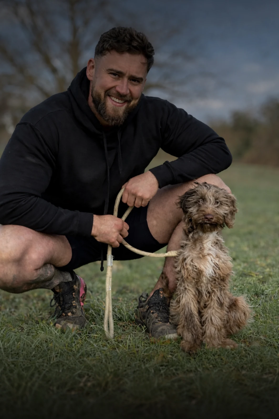 Joe from Hunters Canine Academy with a puppy outdoors